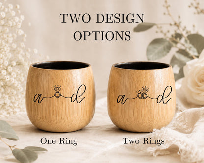 two wooden cups with the same design, placed on a table with a floral background.