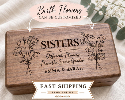 A wooden box with the text "SISTERS" engraved on it, along with illustrations of flowers. The box is labeled as customizable and can be shipped from the US.