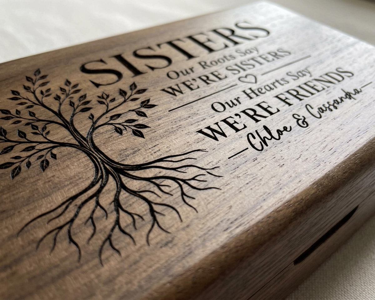 A wooden box with a tree design and text engraved on it.