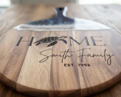 A wooden cutting board with a black handle and the text "HOME Smith Family EST. 1996" printed on it.