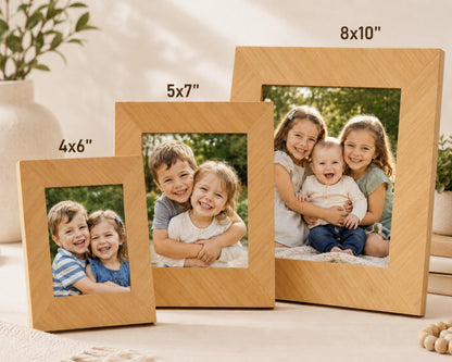 three wooden picture frames, each containing a different family photo. The first frame is 5'7" in size, the second frame is 5'x7" in size, and the third frame is 8'x10" in size. The family photos in the frames capture happy moments of the children and the adults in the family.