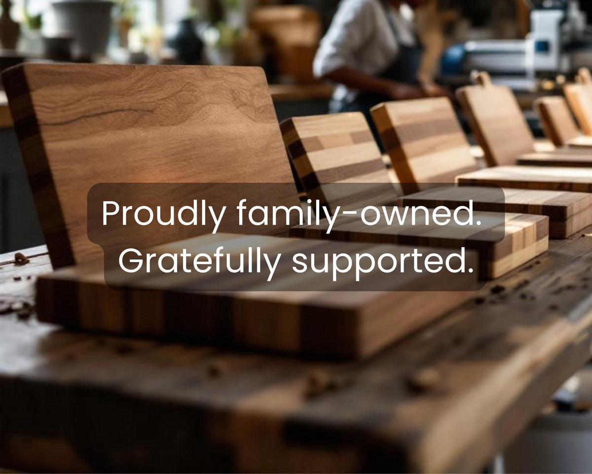 a collection of wooden cutting boards, with a text overlay that reads "Proudly family-owned. gratefully supported."