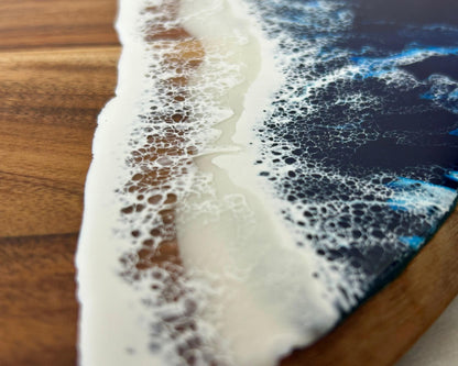 a close-up view of a wooden surface with a white, foamy substance resembling a wave or foam, creating a visually striking contrast against the dark background.