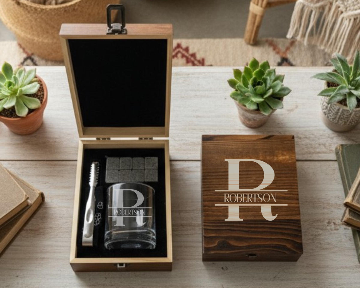a wooden box with a glass and a toothbrush inside, along with a potted plant and a book on a wooden surface.
