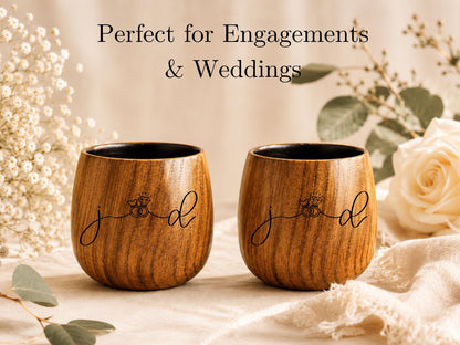 two wooden cups with the word "jod" written on them, placed on a table with white flowers and greenery in the background.