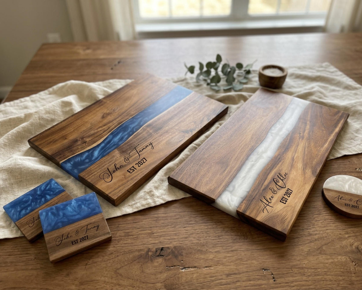 a wooden table with two wooden cutting boards, each with a blue and white design, and several small wooden coasters. There is also a small plant and a candle on the table.