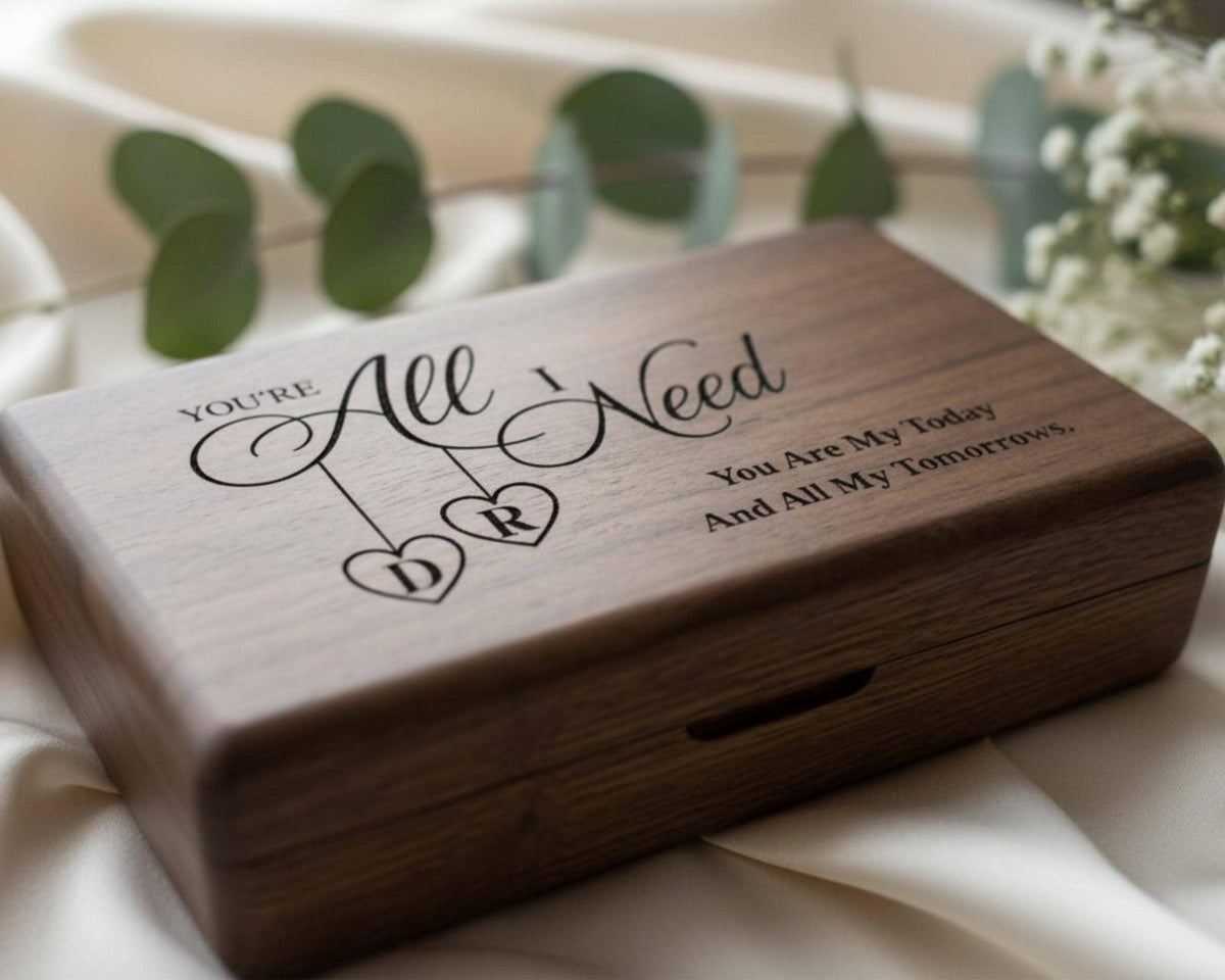 A wooden box with a personalized message engraved on it, sitting on a white cloth.