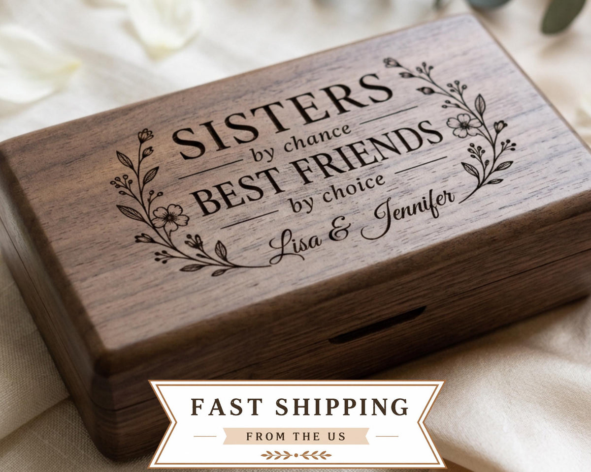 A wooden box with a decorative floral design and text engraved on it.