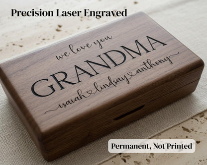 A wooden box with the text "we love you Grandma Isaiah Lindsay Anthony" engraved on it, along with the text "Precision Laser Engraved" and "Permanent, Not Printed" at the bottom.