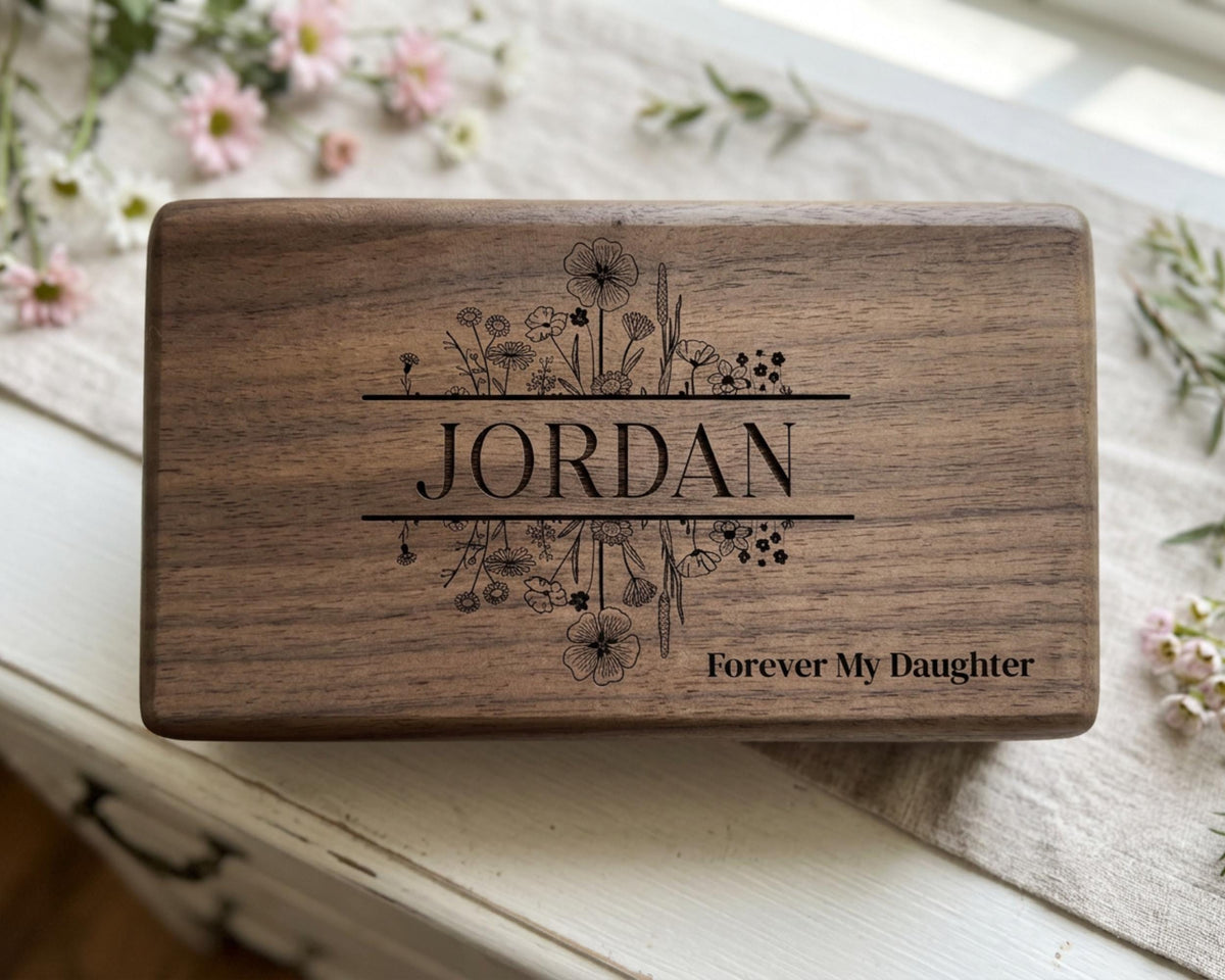 A wooden box with the name "JORDAN" engraved on it, surrounded by floral designs.