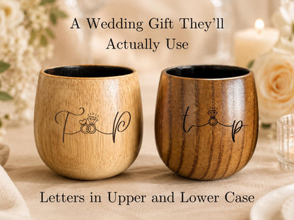 A wooden wine glass with the word "tip" engraved on it, placed on a table with a candle and flowers in the background.