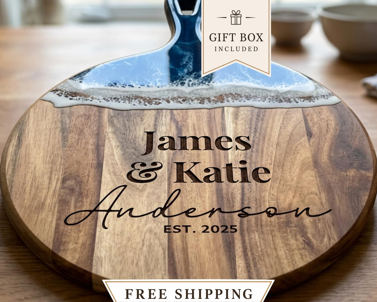 A wooden cutting board with a personalized name engraved on it, along with a gift box included.