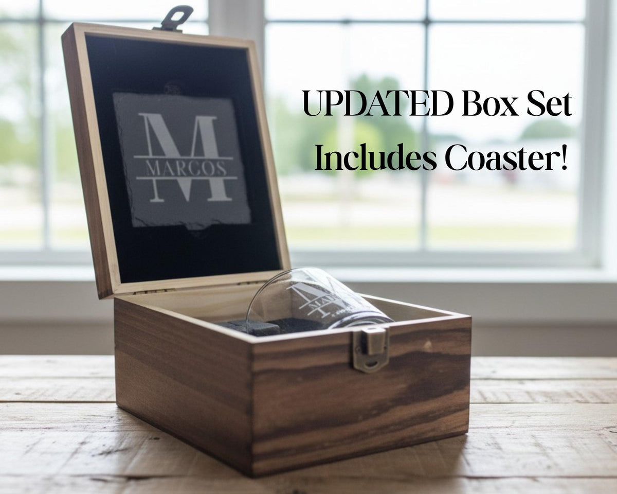 A wooden box with a glass inside, placed on a wooden surface near a window.