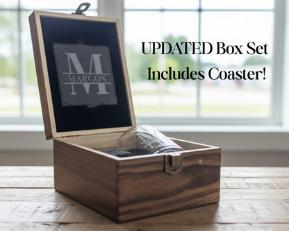A wooden box with a glass inside, placed on a wooden surface near a window.