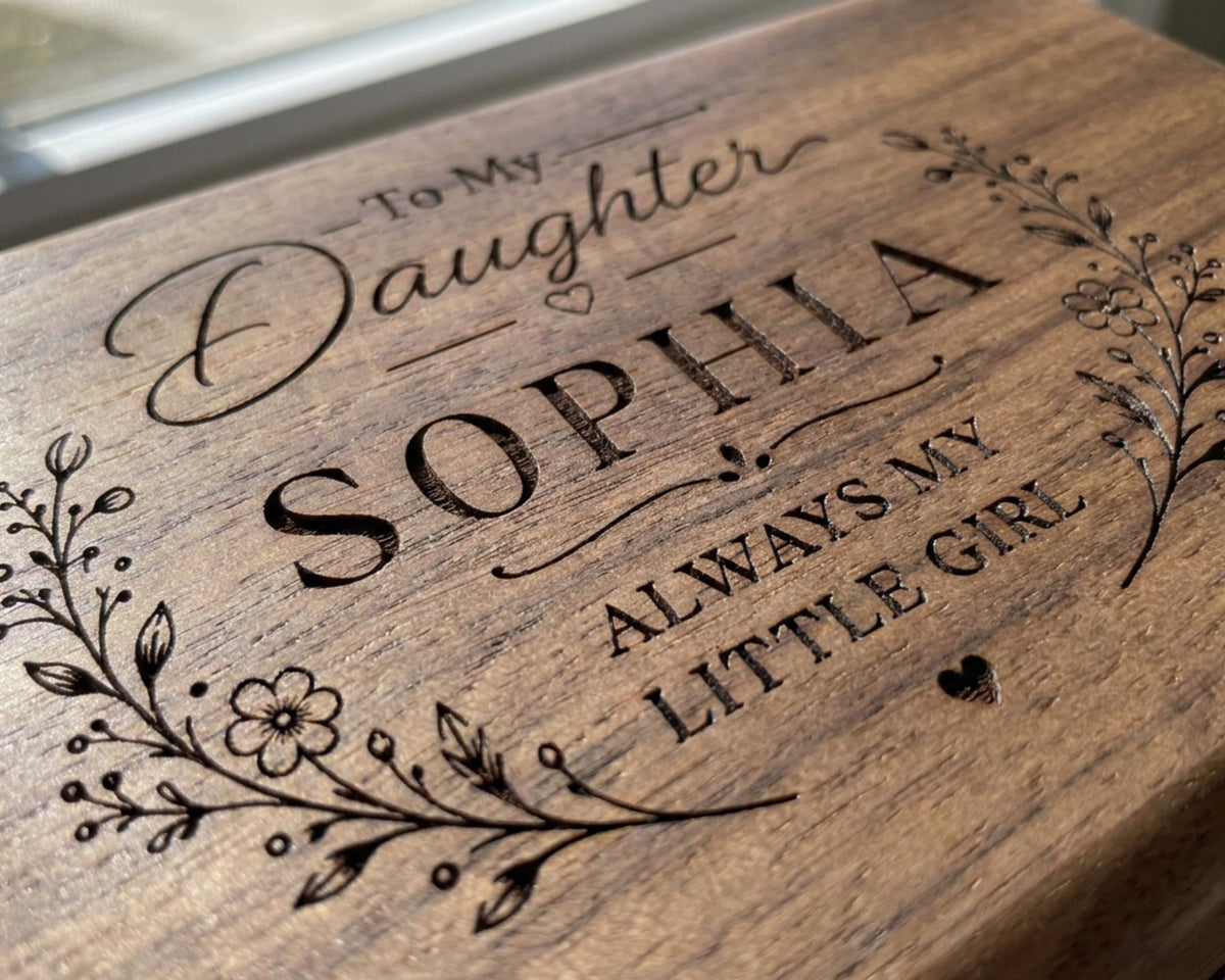 A wooden box with a personalized message engraved on it, reading "To My Daughter Sophia always my little girl".