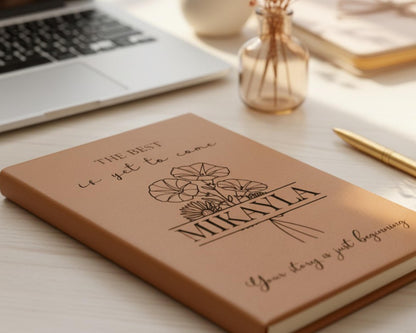 a notebook with a floral design and the text "The best is yet to come" printed on it, along with the name "Mikayla" and the phrase "Your story is just beginning".