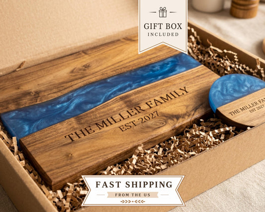 Acacia cutting board with a blue pearl resin river in a gift box