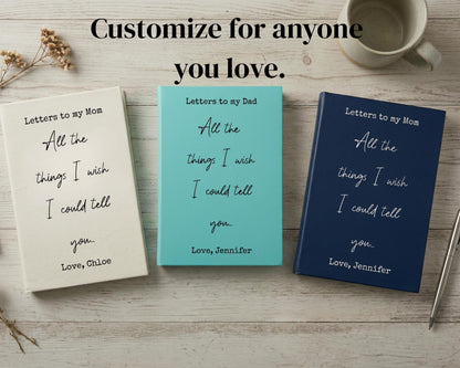 three books titled "Letters to my Dad" and "Letters to my Mom" with handwritten messages, placed on a wooden surface alongside a cup and a pen.