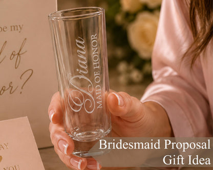 A person holding a glass with the text "Briana of Honor" engraved on it, suggesting a bridesmaid proposal gift idea.