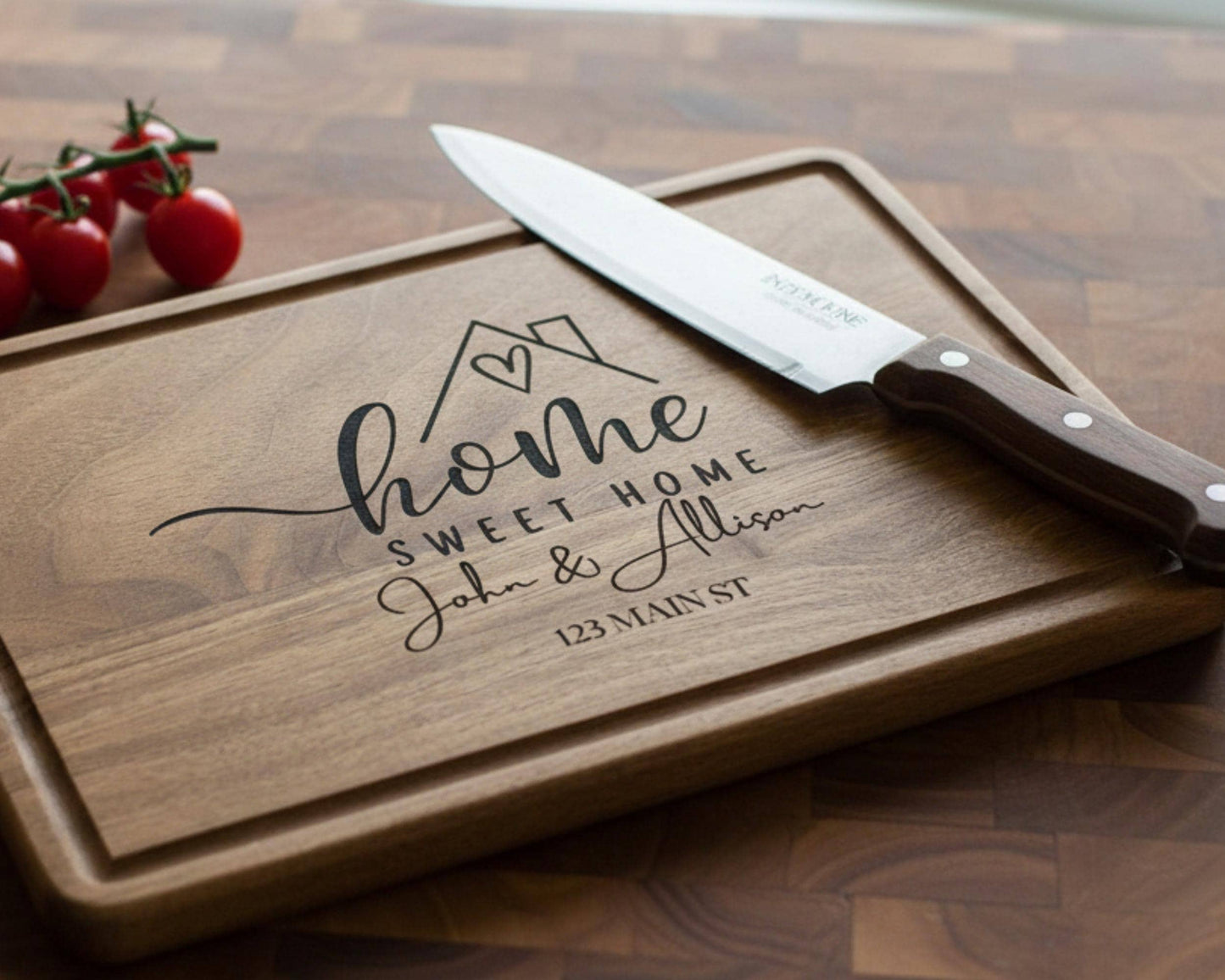 A wooden cutting board with a knife and some cherry tomatoes on a wooden surface.