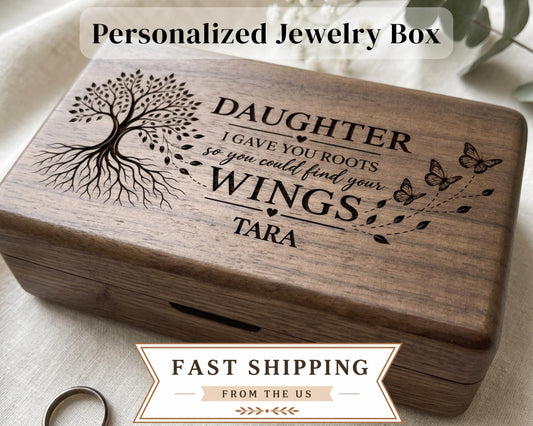 A personalized wooden jewelry box with a tree design and text engraved on it.