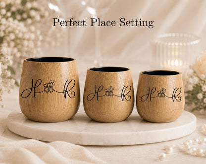 Three wooden wine glasses with the text "Hook" printed on them, arranged on a white marble surface.