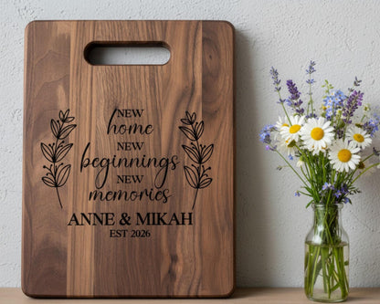 A wooden cutting board with a decorative message and a vase of flowers on a shelf.