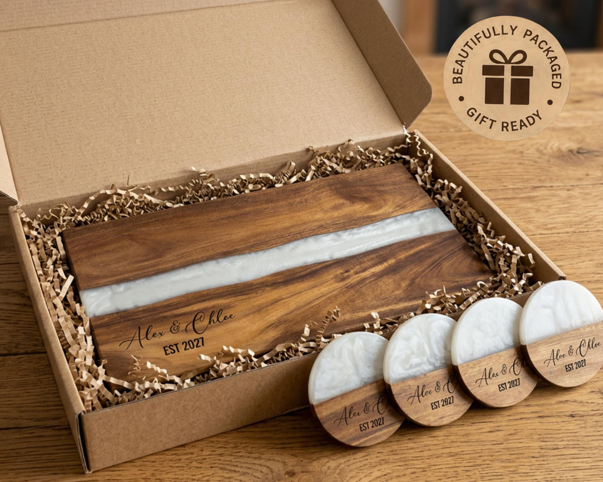 White pearl resin cutting board in a gift box with matching engraved coasters