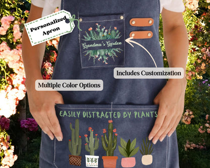 a person wearing a blue apron with a design of cacti and flowers, and the text "Grandma's Garden" on it. The apron has a tag that says "Personalized Apron" and a label that says "Includes Customization". The apron also has a message that says "Easily Distracted by Plants".