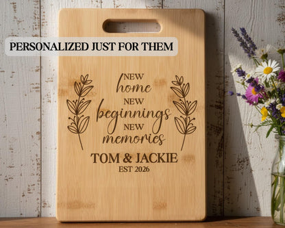 A wooden cutting board with a personalized message engraved on it, placed next to a vase of flowers.