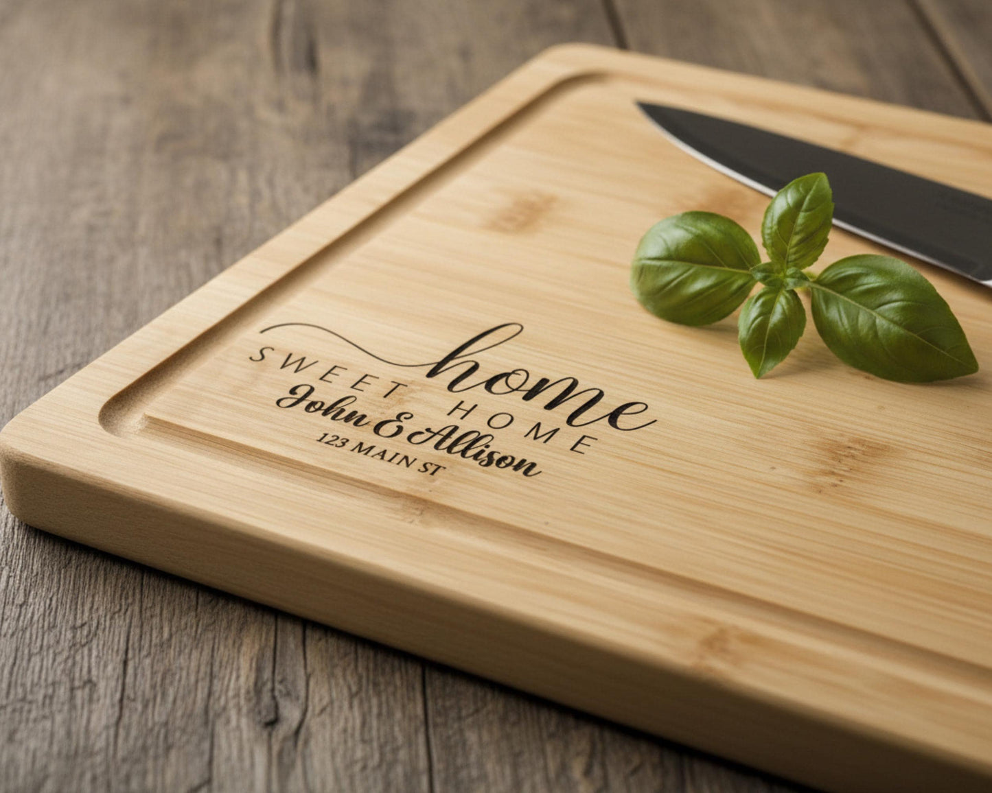 A wooden cutting board with a knife and a sprig of basil on it, along with a personalized message engraved on the board.